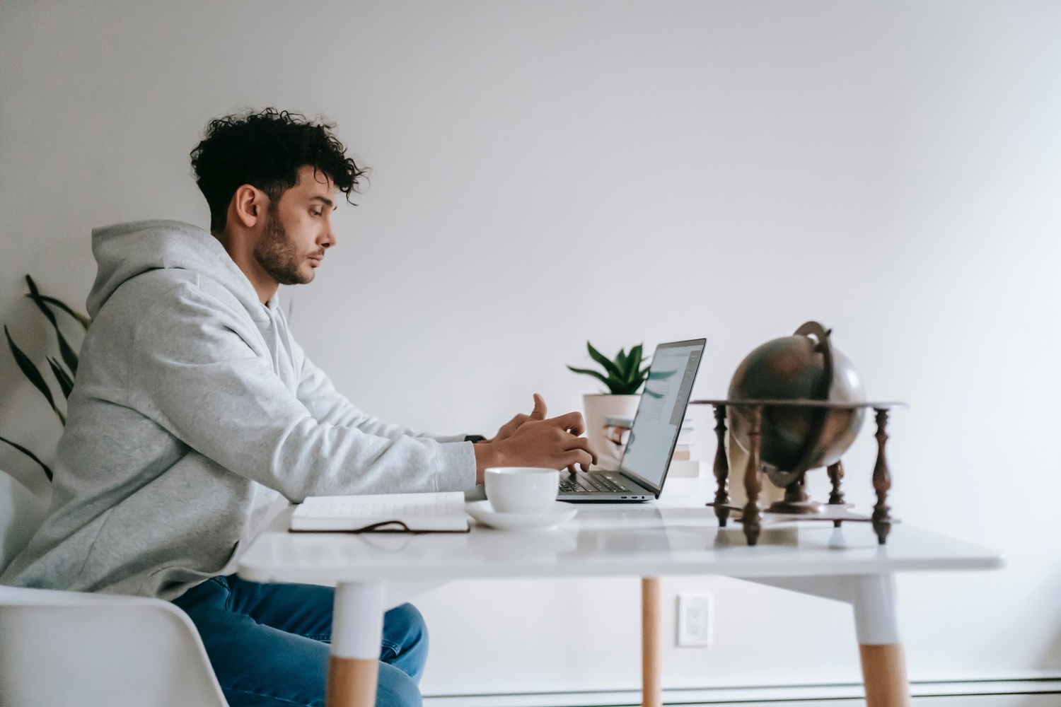 "leerwerkburo reintegratie jongen achter laptop aan tafel"
