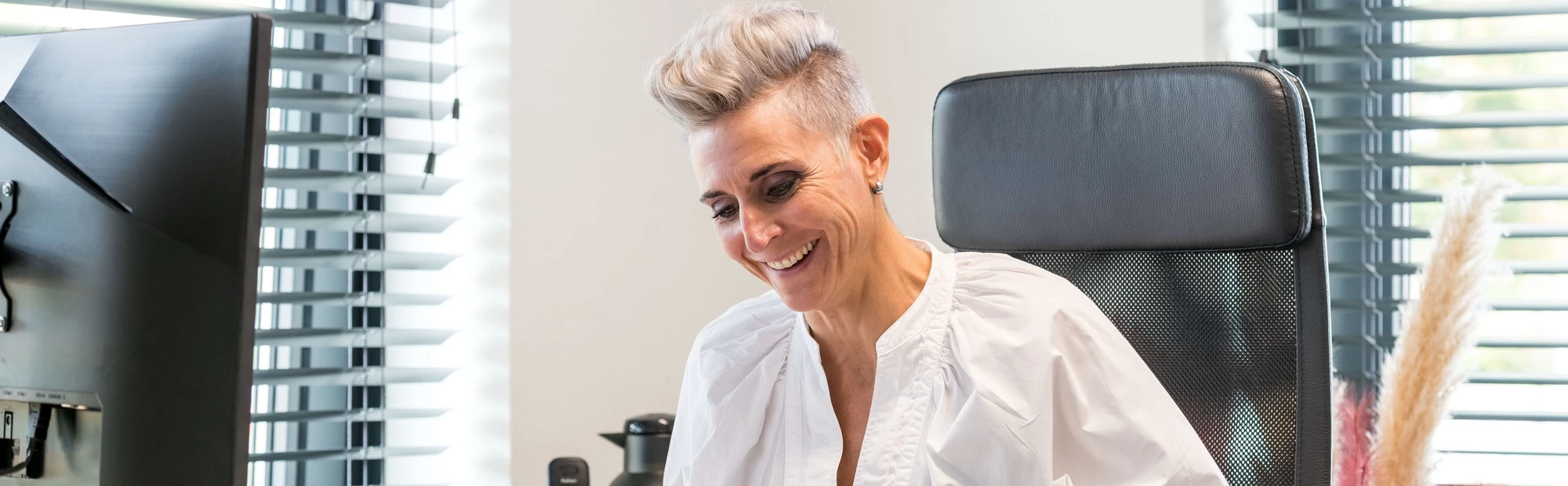 "leerwerkburo reintegratie vrouw met kort haar en witte blouse"